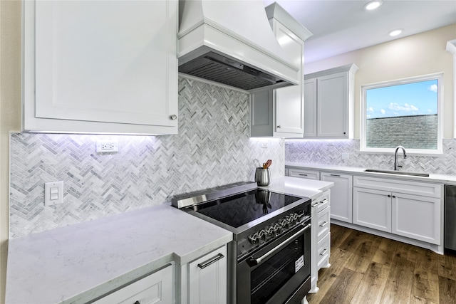 kitchen with stainless steel appliances, custom range hood, dark hardwood / wood-style flooring, sink, and white cabinets