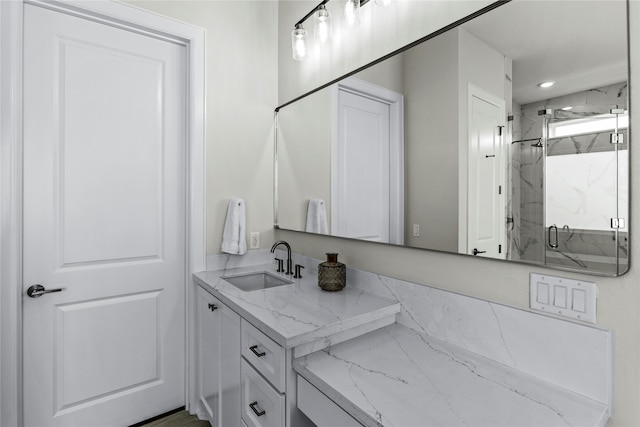 bathroom featuring vanity and a shower with shower door