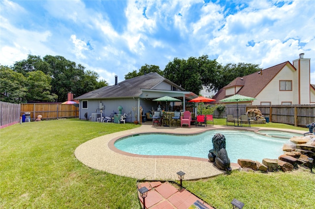 view of swimming pool featuring a patio, an in ground hot tub, and a lawn