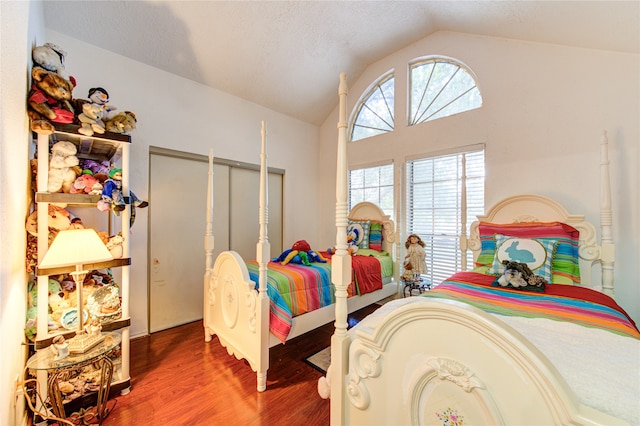 bedroom featuring hardwood / wood-style flooring and vaulted ceiling