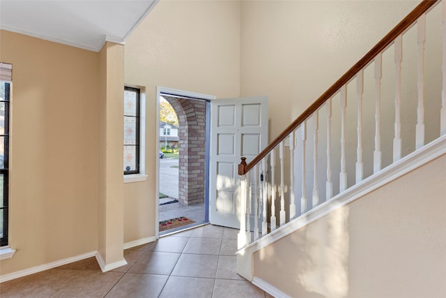 tiled entrance foyer featuring ornamental molding