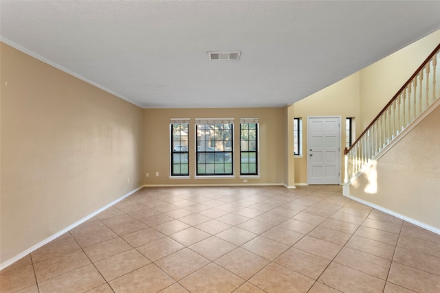 tiled entrance foyer featuring crown molding