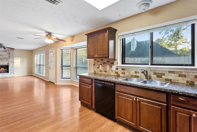 kitchen with light hardwood / wood-style flooring, dishwasher, tasteful backsplash, and plenty of natural light