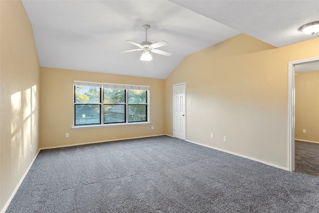 carpeted spare room with ceiling fan and lofted ceiling