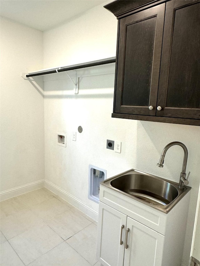 laundry area with hookup for an electric dryer, washer hookup, a sink, baseboards, and cabinet space