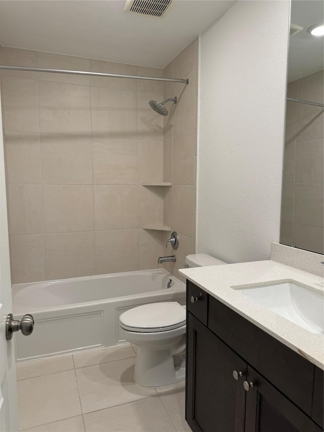 bathroom with toilet, tile patterned flooring, visible vents, and vanity