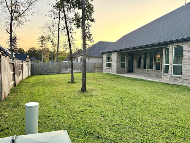 view of yard featuring a patio area and a fenced backyard