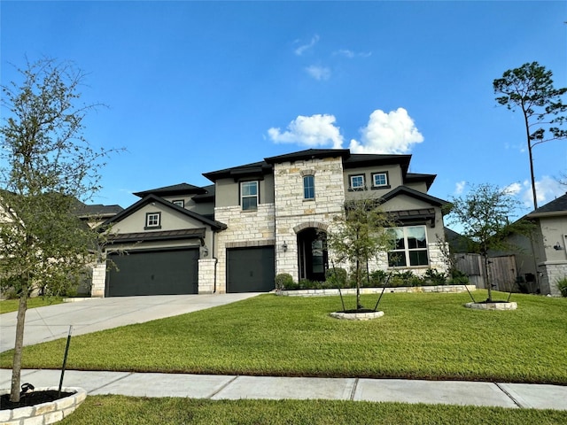 view of front of home with a front yard and a garage