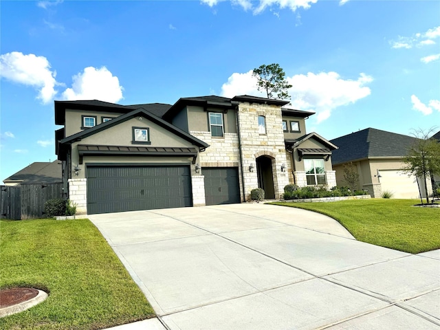 view of front facade with concrete driveway, a front lawn, an attached garage, and stucco siding