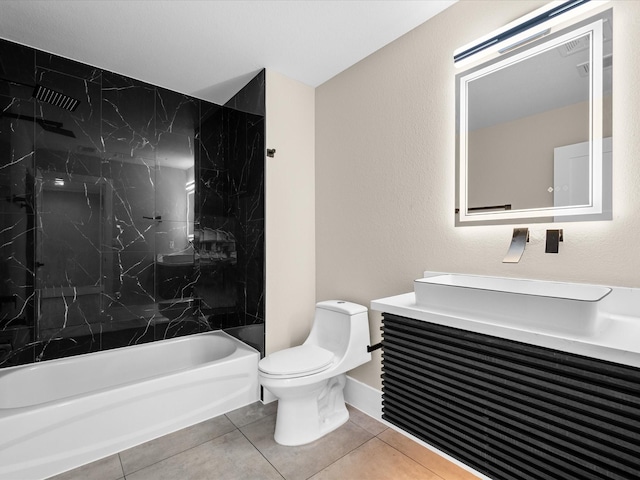 full bathroom featuring toilet, vanity, tiled shower / bath combo, and tile patterned flooring