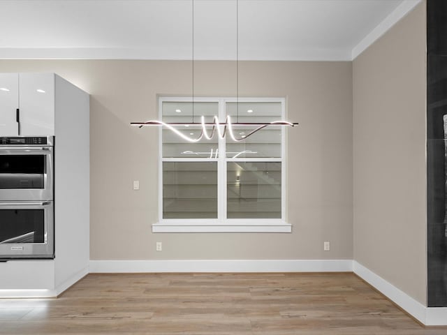 unfurnished dining area featuring light hardwood / wood-style floors