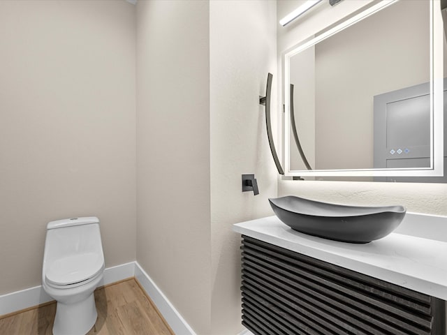 bathroom featuring hardwood / wood-style floors, toilet, and vanity