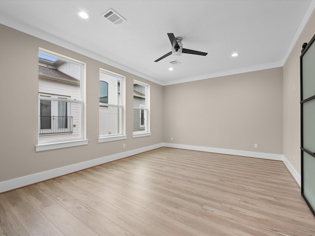 empty room with light wood-type flooring, ceiling fan, and ornamental molding