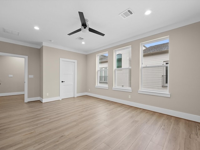 unfurnished room with plenty of natural light, ornamental molding, and light wood-type flooring