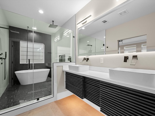 bathroom featuring vanity, shower with separate bathtub, and tile patterned flooring