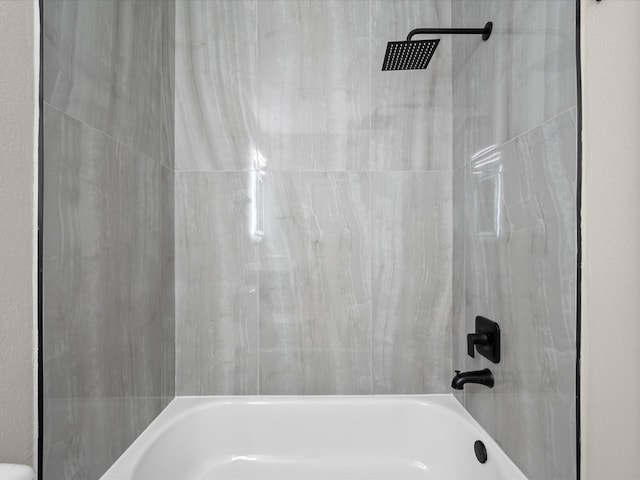 bathroom with bathing tub / shower combination