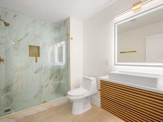 bathroom featuring a shower with door, toilet, tile patterned flooring, and vanity