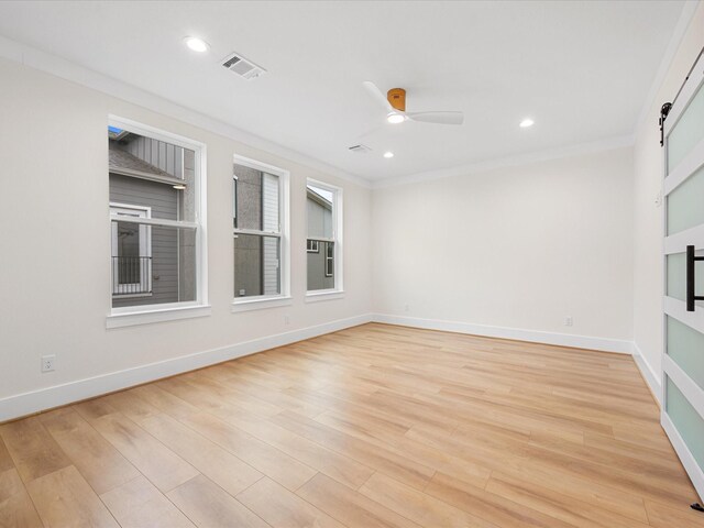 empty room with ceiling fan, light hardwood / wood-style flooring, and ornamental molding