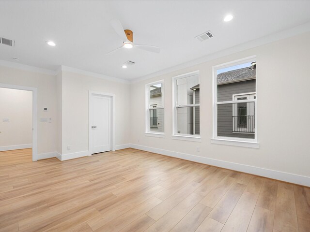 unfurnished room with ceiling fan, plenty of natural light, light hardwood / wood-style flooring, and ornamental molding