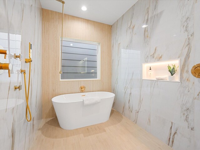 bathroom featuring shower with separate bathtub