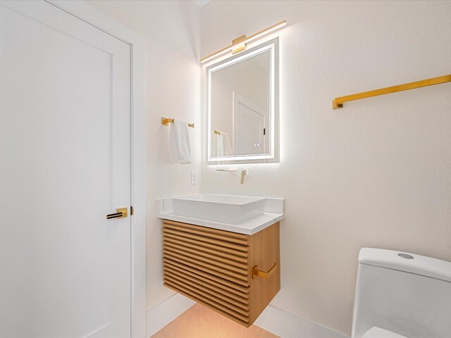 bathroom with vanity and toilet