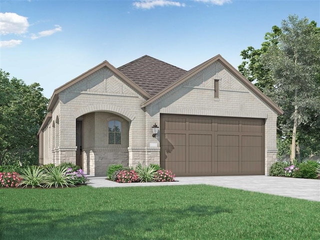 view of front of home with a front yard and a garage