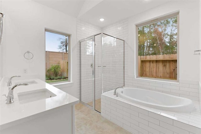 bathroom featuring vanity, tile patterned floors, separate shower and tub, and a wealth of natural light