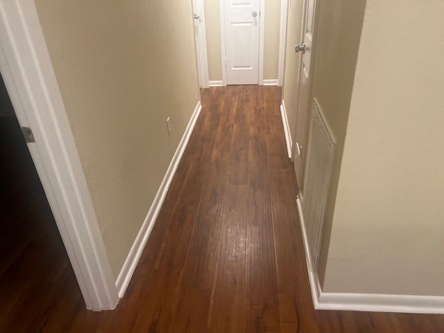 corridor with dark hardwood / wood-style floors