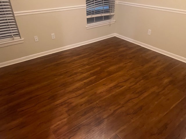 unfurnished room featuring dark hardwood / wood-style flooring