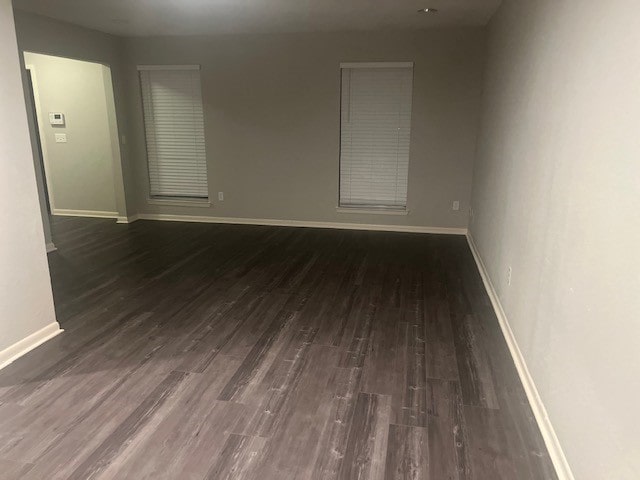 spare room featuring dark hardwood / wood-style flooring