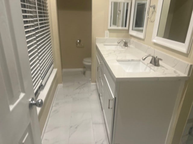 bathroom featuring vanity and toilet