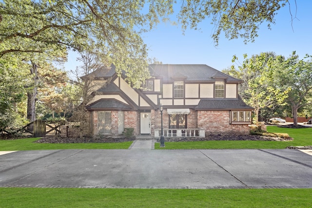 tudor house featuring a front yard