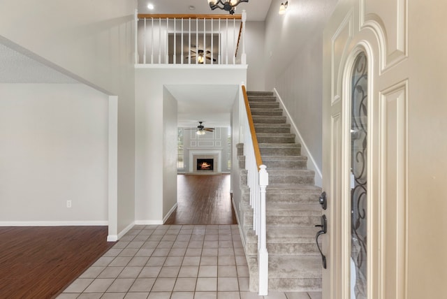 foyer entrance with hardwood / wood-style floors and a towering ceiling