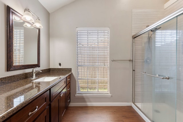 bathroom featuring vanity, hardwood / wood-style floors, and a shower with shower door