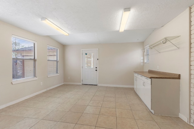 interior space with vaulted ceiling and a textured ceiling