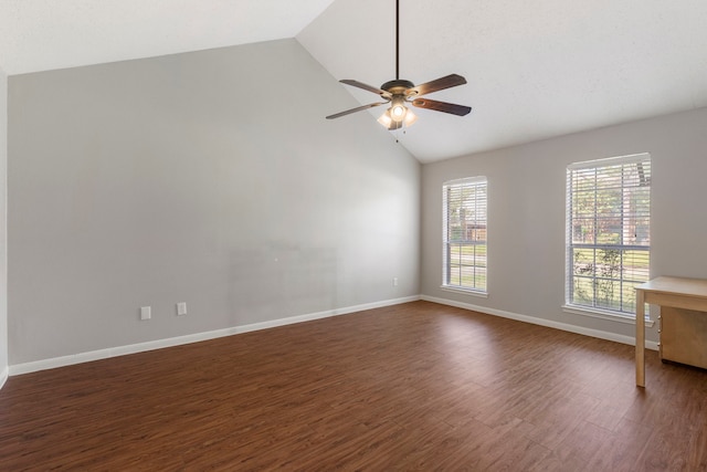 empty room with dark wood-type flooring, a wealth of natural light, ceiling fan, and high vaulted ceiling