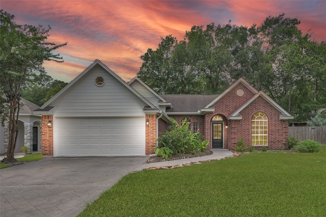 ranch-style home featuring a yard and a garage