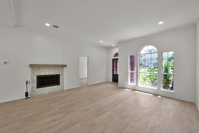 unfurnished living room featuring ornamental molding and light hardwood / wood-style floors