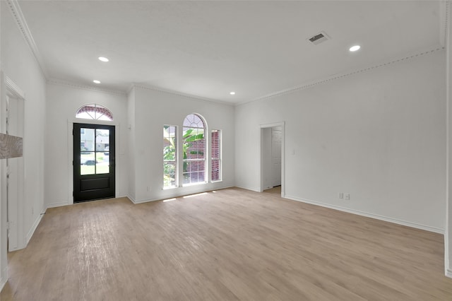 entrance foyer featuring crown molding and light hardwood / wood-style floors