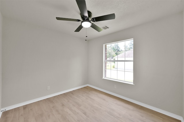 spare room featuring light hardwood / wood-style flooring, a textured ceiling, and ceiling fan