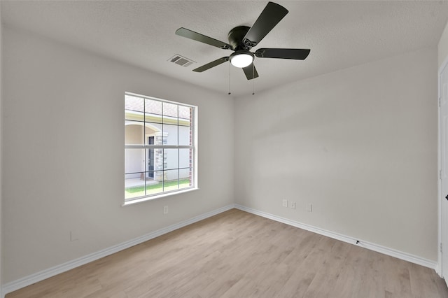 spare room featuring light hardwood / wood-style floors, a textured ceiling, and ceiling fan