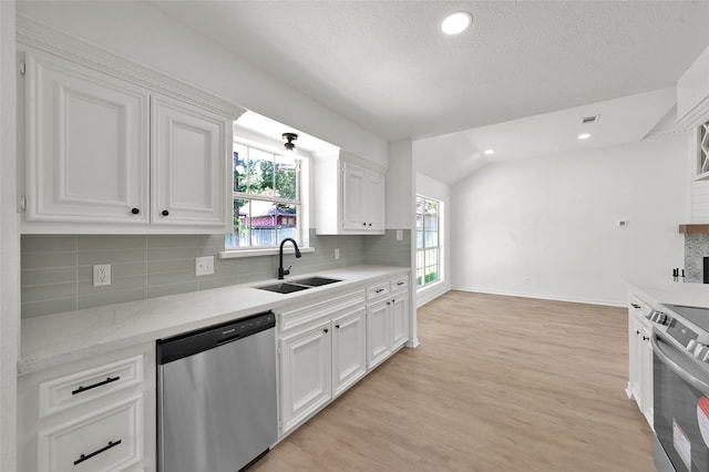 kitchen with white cabinets, stainless steel appliances, and a healthy amount of sunlight