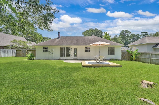 back of house with a patio and a lawn