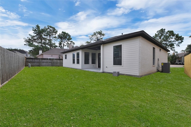 rear view of property featuring a patio area, a lawn, and cooling unit