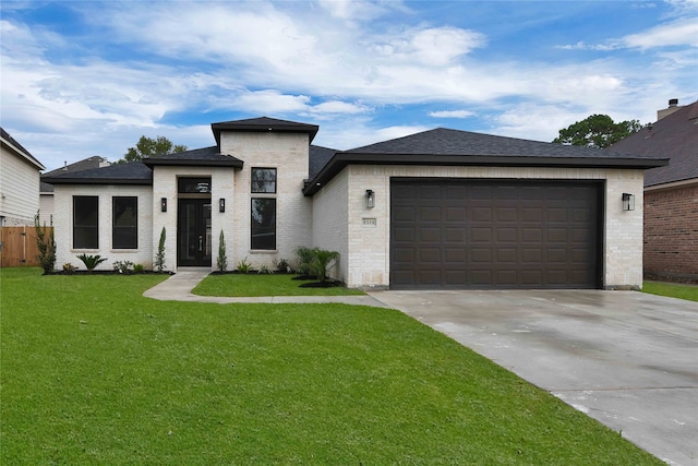 view of front of house featuring a front yard and a garage