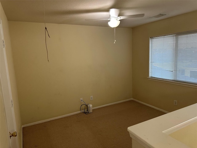 laundry room featuring ceiling fan, sink, and carpet floors