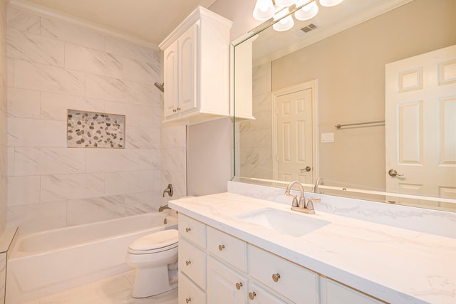 full bathroom featuring toilet, tiled shower / bath, vanity, ornamental molding, and tile patterned flooring