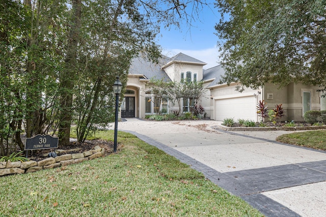 view of front of property with a front lawn and a garage