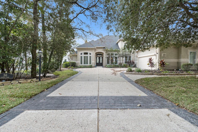 view of front of house featuring a front lawn and a garage