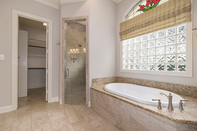 bathroom featuring ornamental molding and shower with separate bathtub